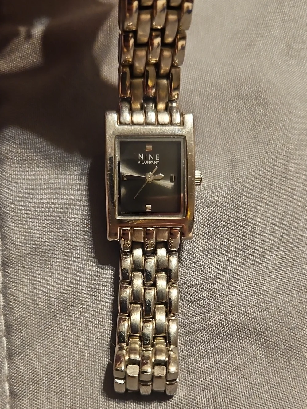 Nine & Co. Women's Silver Tone Bracelet Watch with Black Dial